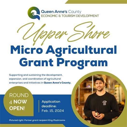 picture of a man holding a bottle in a warehouse