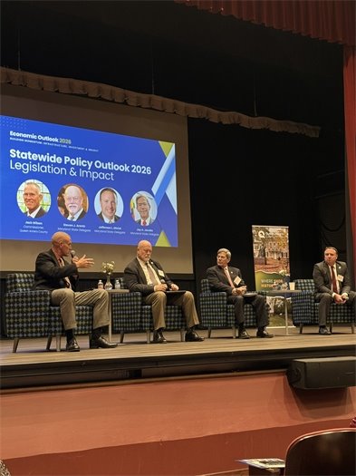 4 men sitting on a stage