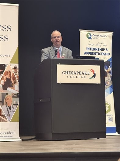man standing behind a podium
