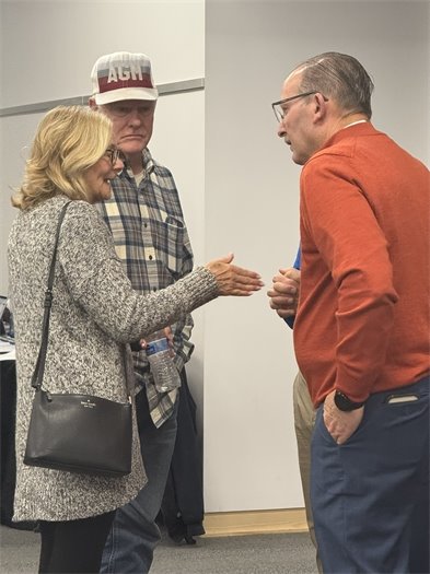 2 men and a woman talking