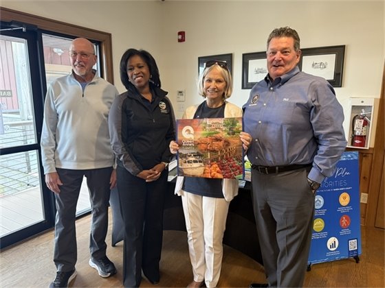 two men and two women standing with a shopping bag