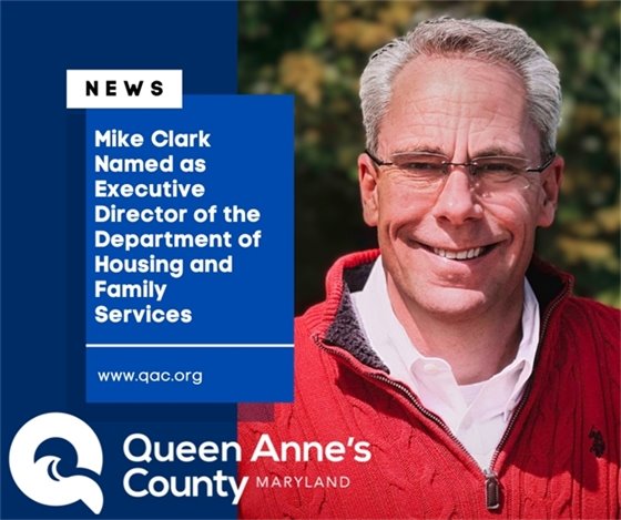 man smiling and wearing a red sweater
