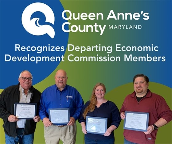 picture of three men and a woman holding certificates